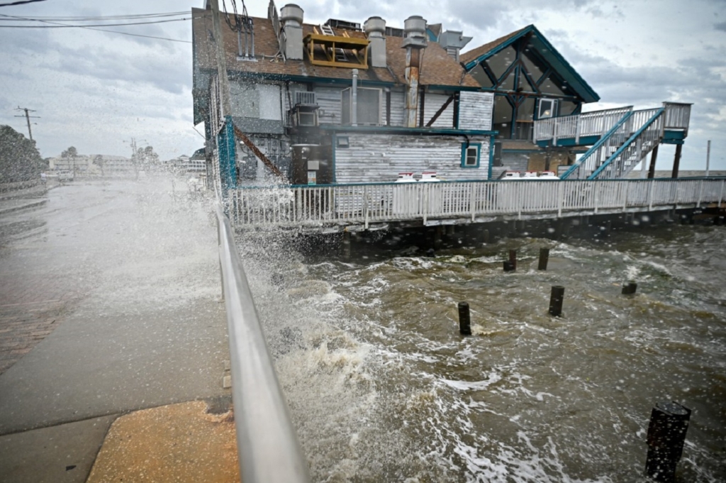 Waves crash against a building ahead of the arrival of Hurricane Helene in Cedar Key, Florida, on September 26, 2024. - Parts of Florida face "unsurvivable" conditions when Hurricane Helene hits later Thursday, the US weather service said, warning that howling wind will drive destructive waves and storm surge as high as 20 feet (six meters) onto the low-lying coast. Residents heeded mass evacuation orders and fled ahead of the incoming hurricane -- projected to be one of the largest Gulf of Mexico storms in decades. (Photo by Miguel J. Rodriguez Carrillo / AFP)